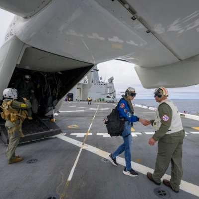 NASA Administrator Jared Isaacman, left, is greeted by Capt. Erik Kenny, commanding officer, USS John P. Murtha (LPD, after a...