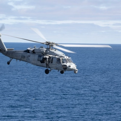 A U.S. Navy MH-60 Seahawk from Helicopter Sea Combat Squadron (HSC) 23 departs from the flight deck of USS John...