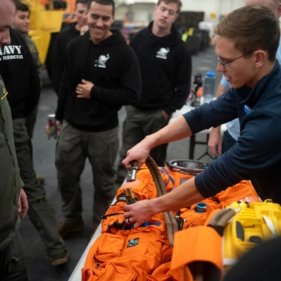 Nicholas Houghton, an Orion Crew Survival System engineer at NASA’s Johnson Space Center, left, conducts familiarization training with the Orion...